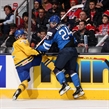 TORONTO, CANADA - JANUARY 2: Sweden's Sebastian Aho #2 takes a hit from Finland's Kasperi Kapanen #24 during quarterfinal round action at the 2015 IIHF World Junior Championship. (Photo by Andre Ringuette/HHOF-IIHF Images)